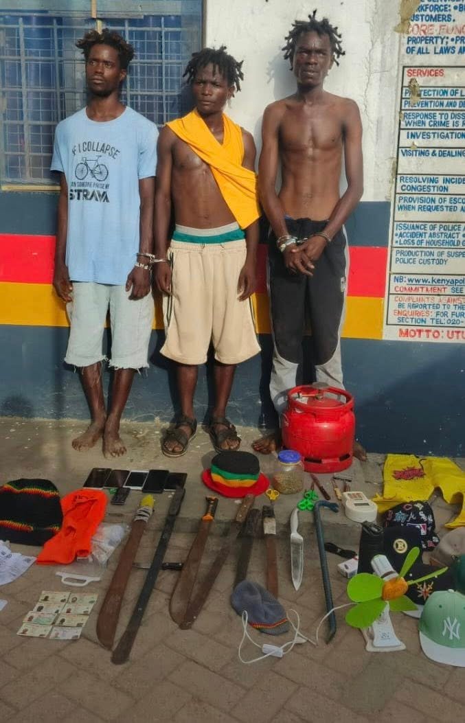 Robbery suspects with exhibits at Police Station