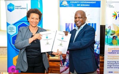 Deputy Governor Dr. Mathew Owili and SNV Country Director for Kenya and Burundi Rebecca Hallam display a signed agreement after formalizing their partnership.