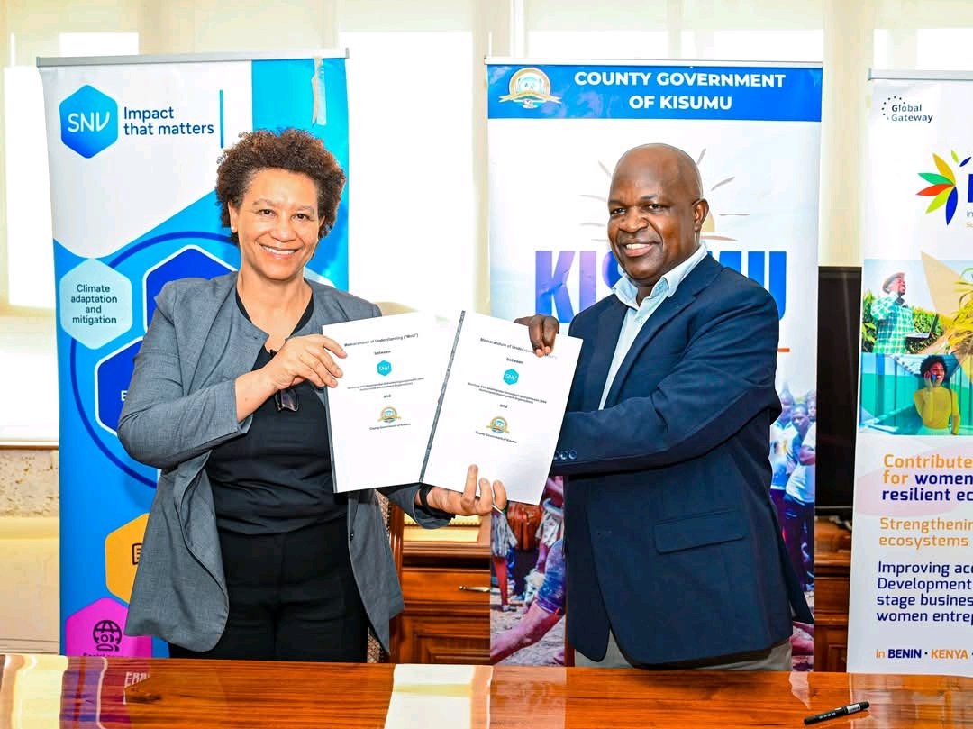 Deputy Governor Dr. Mathew Owili and SNV Country Director for Kenya and Burundi Rebecca Hallam display a signed agreement after formalizing their partnership.