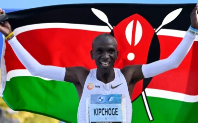 Eiud Kipchoge holding Kenyan Flag as he celebrates Berlin Marathon victory in 2022