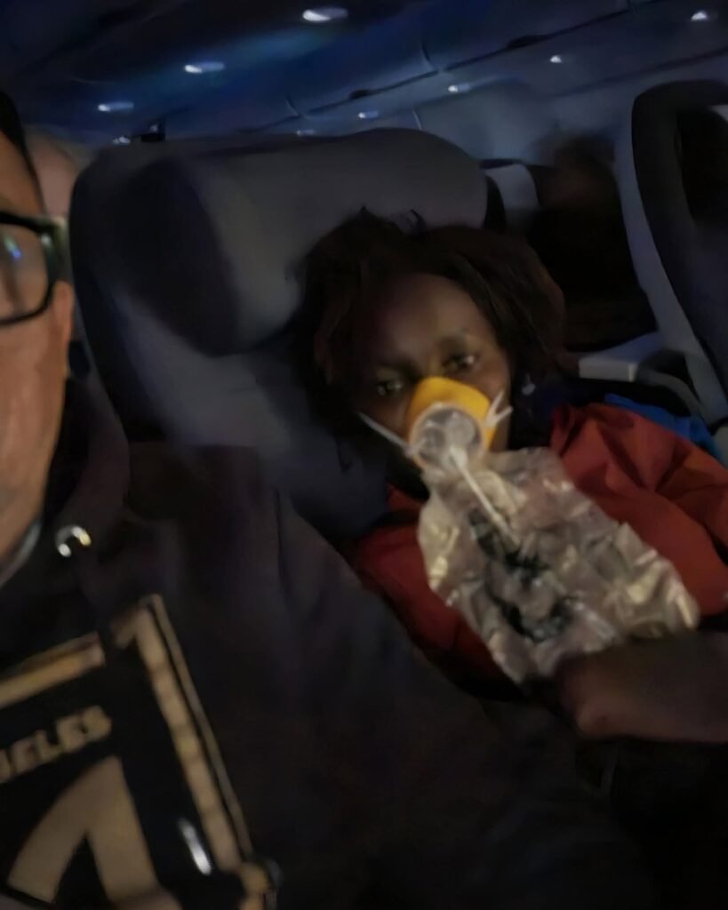 : Linda Chebet Gomez flight medical emergency showing her wearing an oxygen mask on an airplane seat next to her husband.