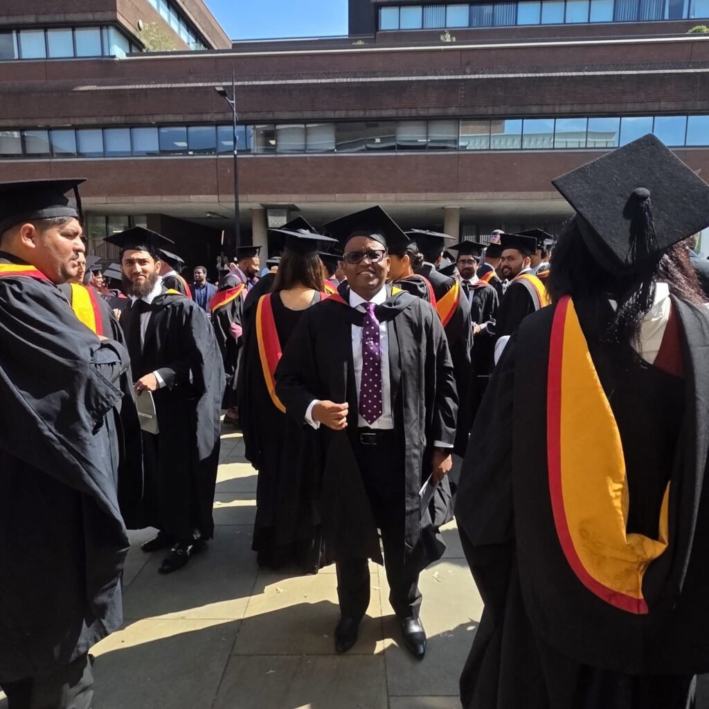Amb. Dr. Joseph Warui master's degree graduation ceremony at the University of Wolverhampton alongside fellow graduates.