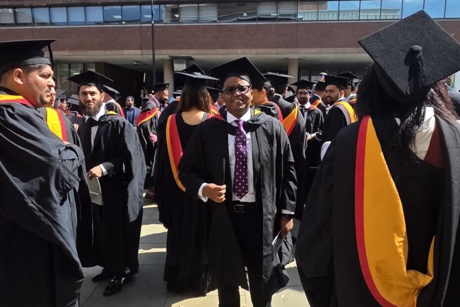 Amb. Dr. Joseph Warui master's degree graduation ceremony at the University of Wolverhampton alongside fellow graduates.