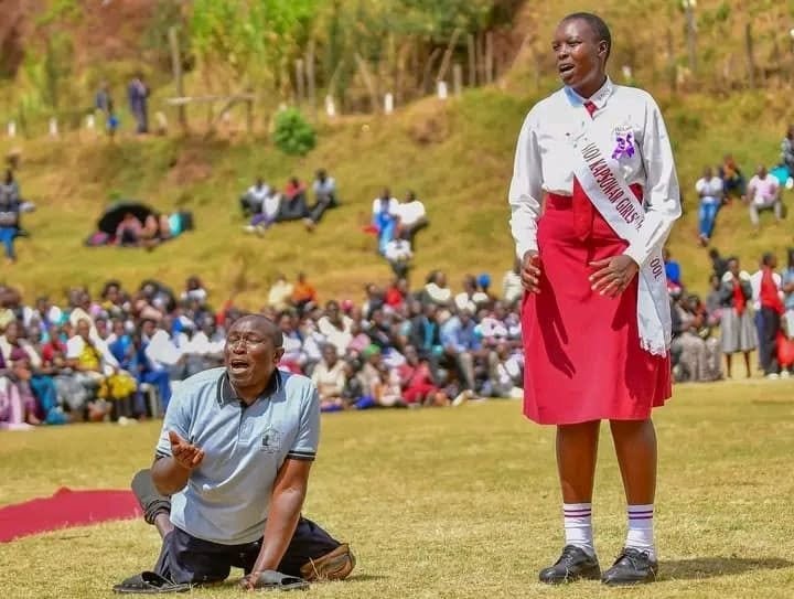 Richard Nyamunyamu, a disabled father, singing with his daughter at Moi Kapsowar Girls Prayer Day.