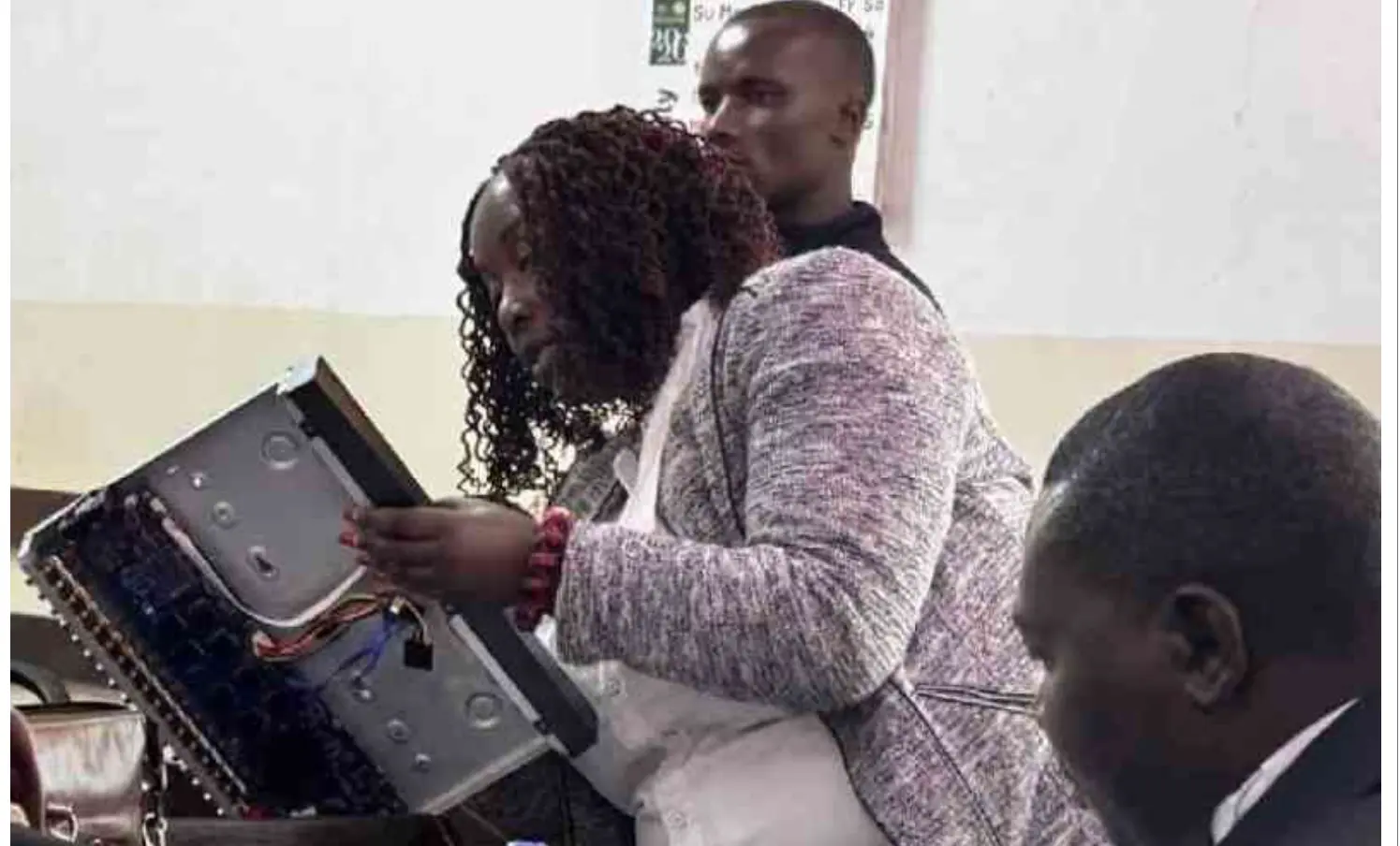 Prosecutor Gikui Gichuhi holding an open CCTV Digital Video Recorder (DVR) to read its serial number during the Albert Ojwang murder trial before High Court Judge Diana Kavedza.