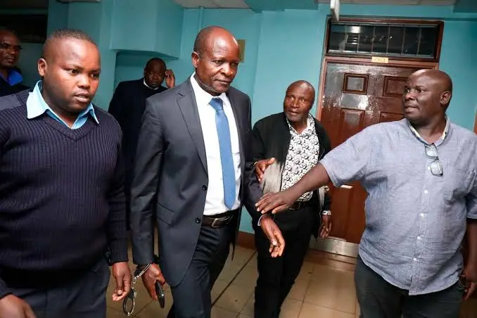 Former Migori Governor Okoth Obado handcuffed and escorted by court officers following the Sharon Otieno murder verdict at Milimani Law Courts.