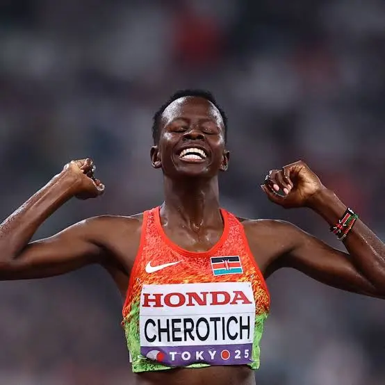Kenyan runner Faith Cherotich celebrating with raised fists in her red and green national kit.