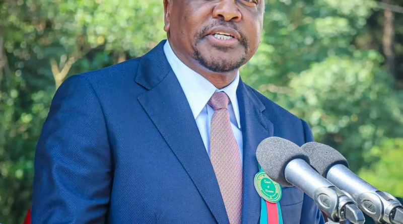 Kenya Agriculture Cabinet Secretary Mutahi Kagwe speaking into microphones at a podium during an official event.