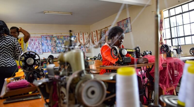 Kenyan women at a Nairobi tailoring workspace, illustrating women's economic empowerment and entrepreneurship.