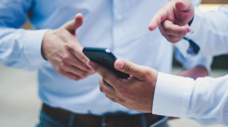 Smartphone being used for mobile finance, illustrating how to check whether a loan app is licensed by CBK.