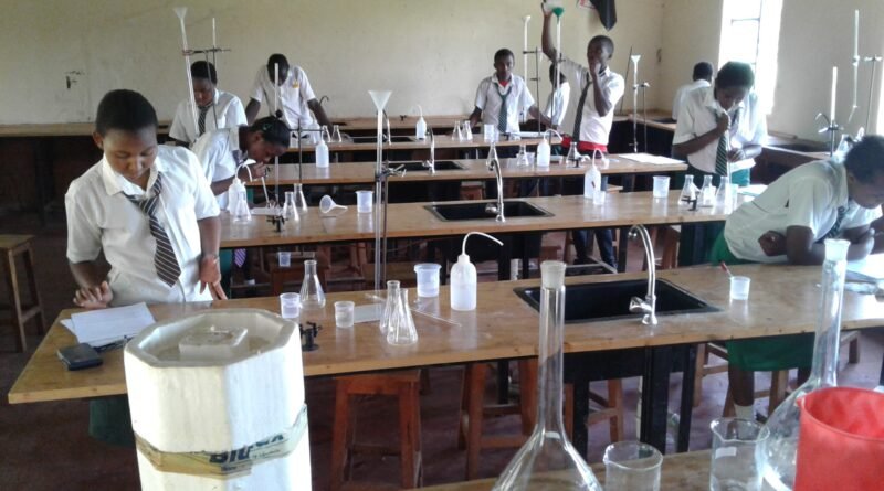 Students seated at desks taking an exam in Kenya