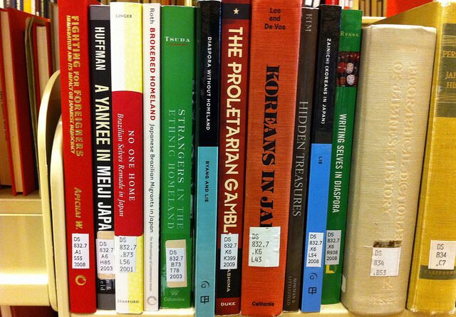Books arranged on a library shelf; illustrative image, not the Migori library donation