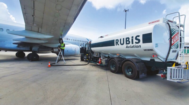 Rubis Aviation tanker refuelling a commercial aircraft at an airport.