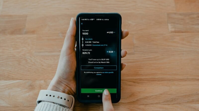 Smartphone used for a money transfer, illustrating how to verify a licensed remittance provider in Kenya.