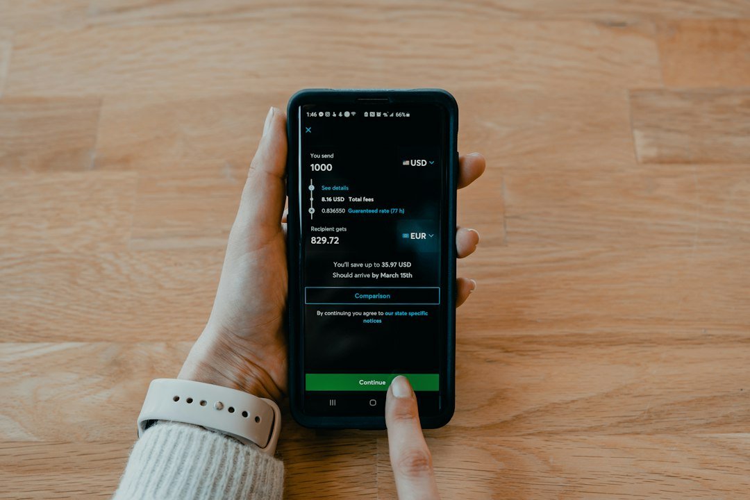 Smartphone used for a money transfer, illustrating how to verify a licensed remittance provider in Kenya.